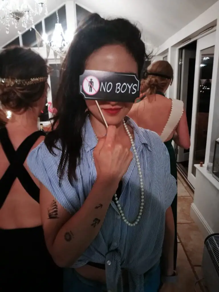 Zoe tehrani at a hen party dressed up with fake tattoos and a 'no boys' sign