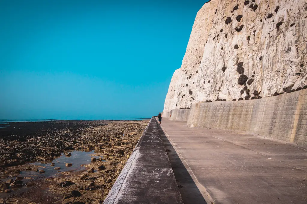 A man running on the under cliff path from Newhaven to Brighton.