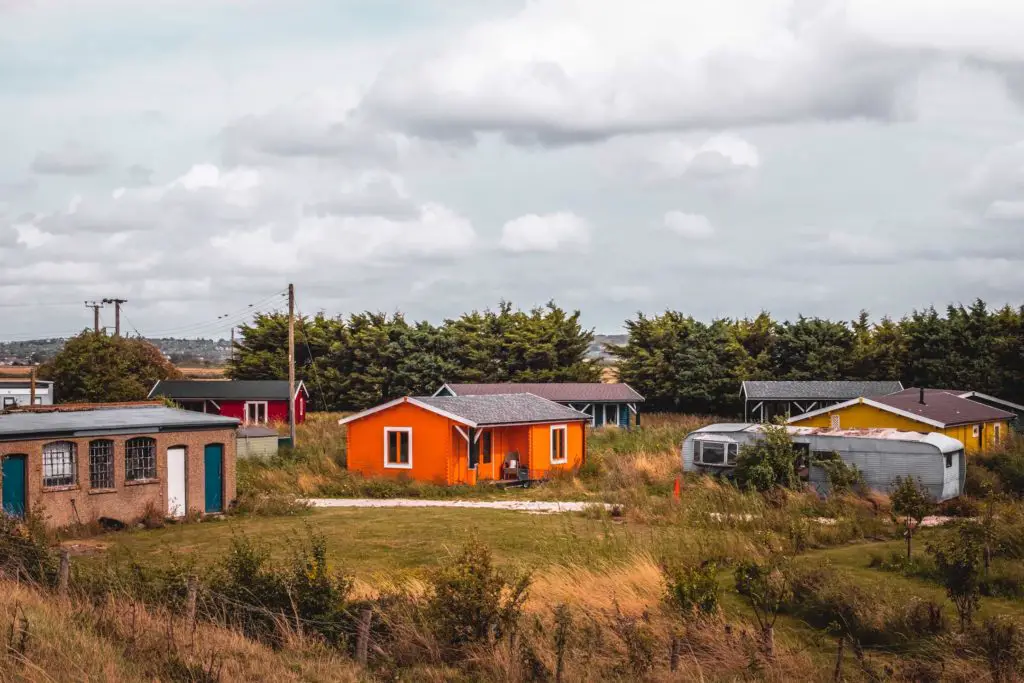 Colourful cabins in grassy land. 