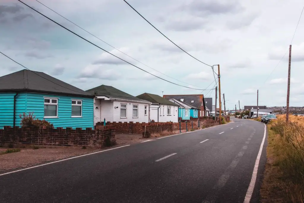 A residential road in Seasalter with blue and white cabins.