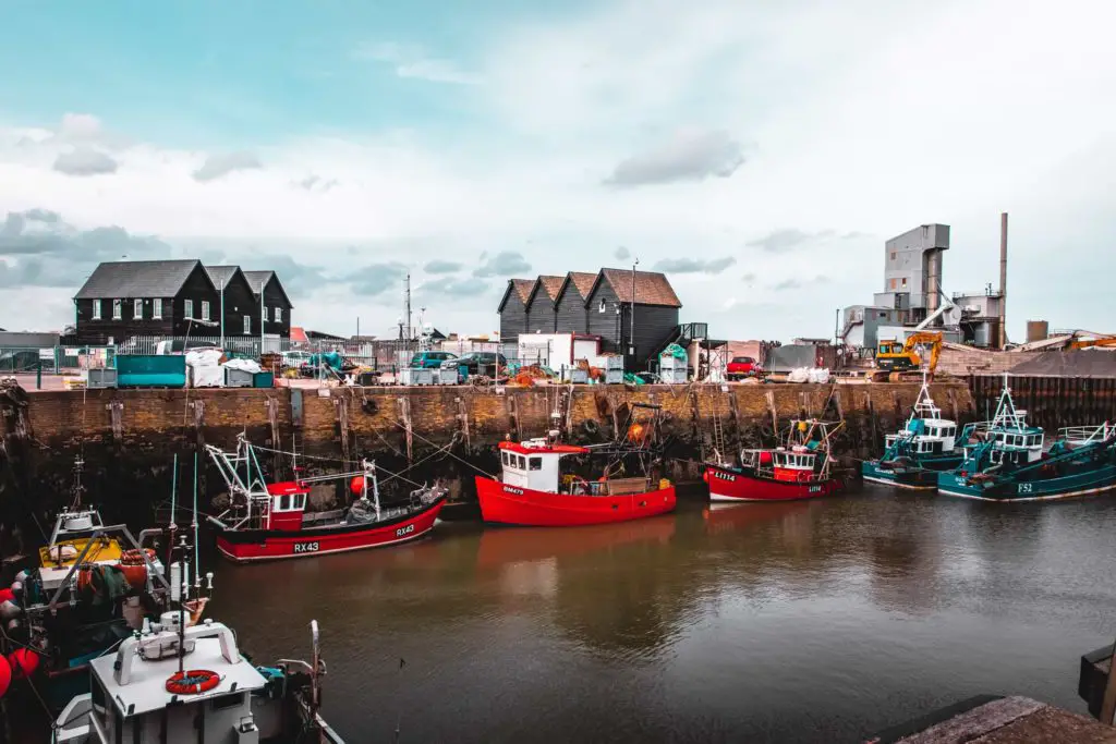 The harbour at Whitstable with its red fishing boats.