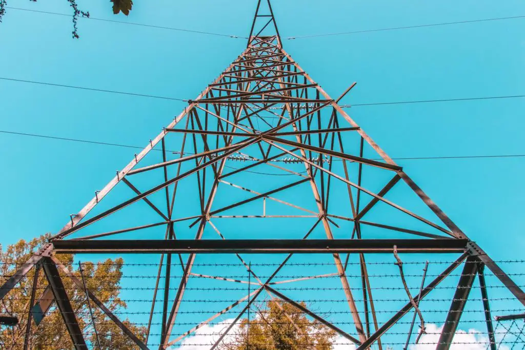 Standing under a telephone pylon looking up. The sky is bright blue.