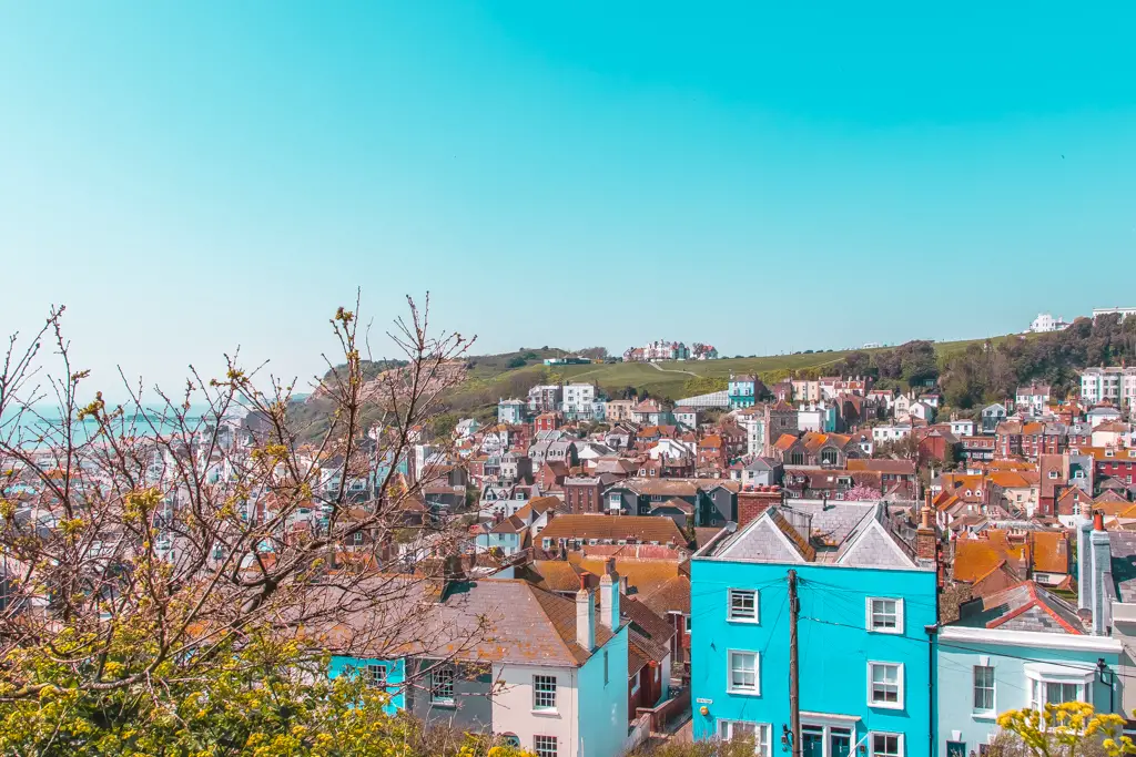 A view overlooking the buildings of Hastings, with a blue sky backdrop.