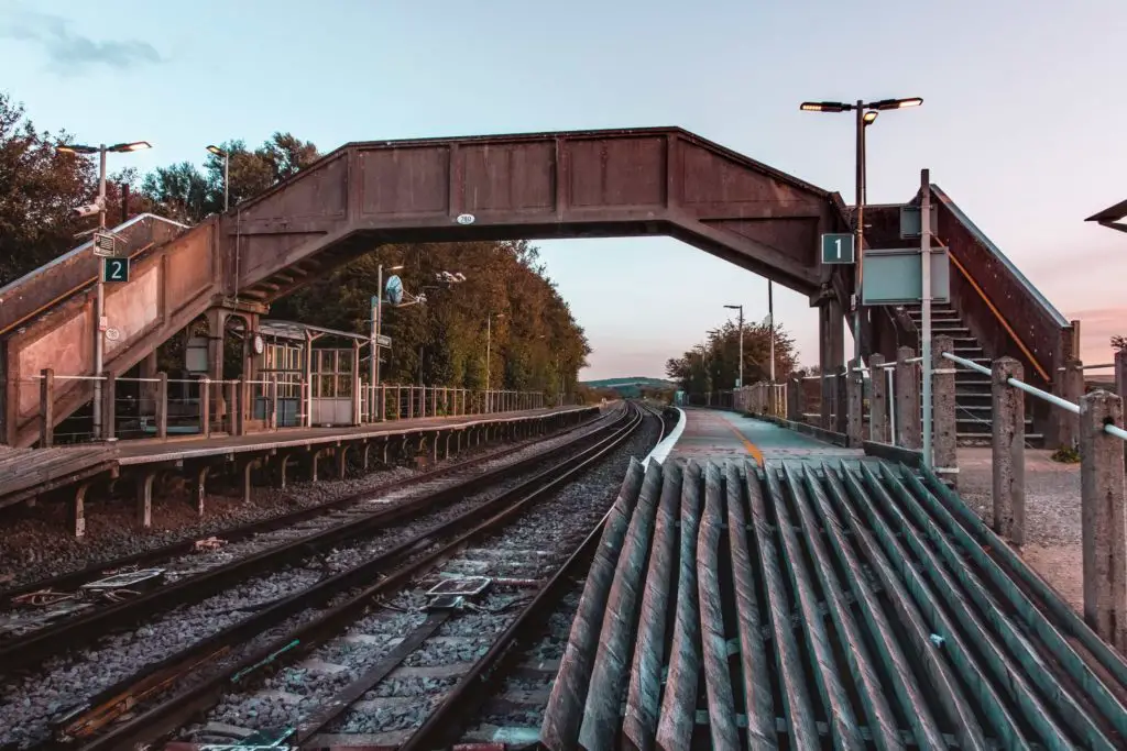 Southease train station. Looking at the train tracks and walking bridge over the tracks.