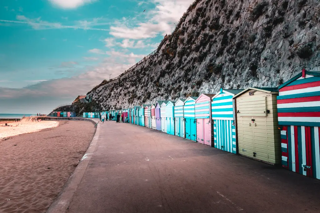 Colourful beach huts under white cliffs on the walk from Margate to Broadstairs.