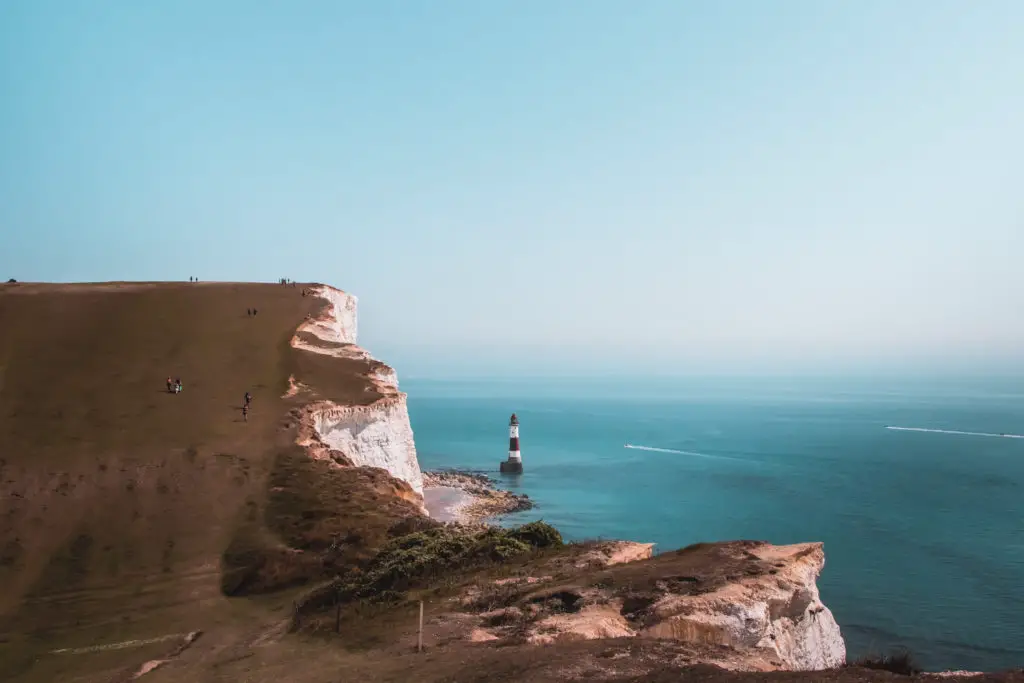 Beachy head lighthouse in the blue sea on the walk from Seaford to Eastbourne