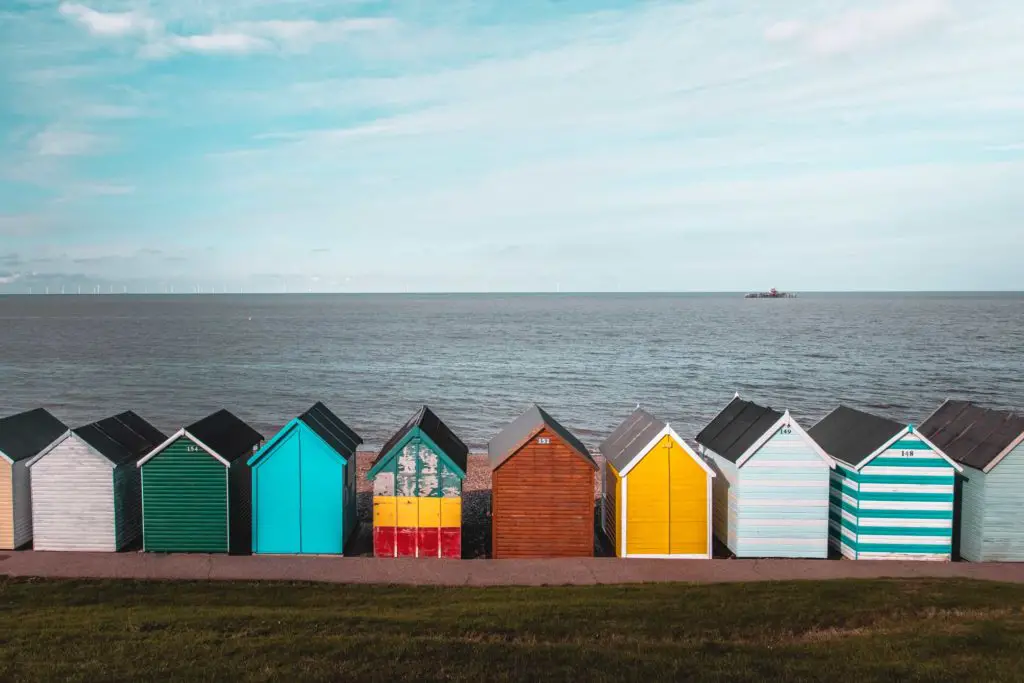 A row of colourful beach huts looking out to the sea on the coastal walk from Whitstable to Herne Bay.