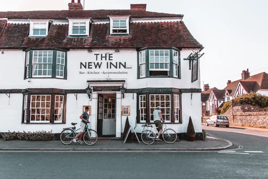 A pub in Winchelsea, with two cyclists peering in the window.