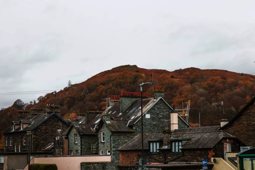 A few houses in Ambleside with a backdrop of Todd Crag on a cloudy day.