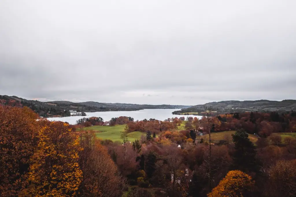 A view down to Lake Windemere surrounded by green fields and trees.