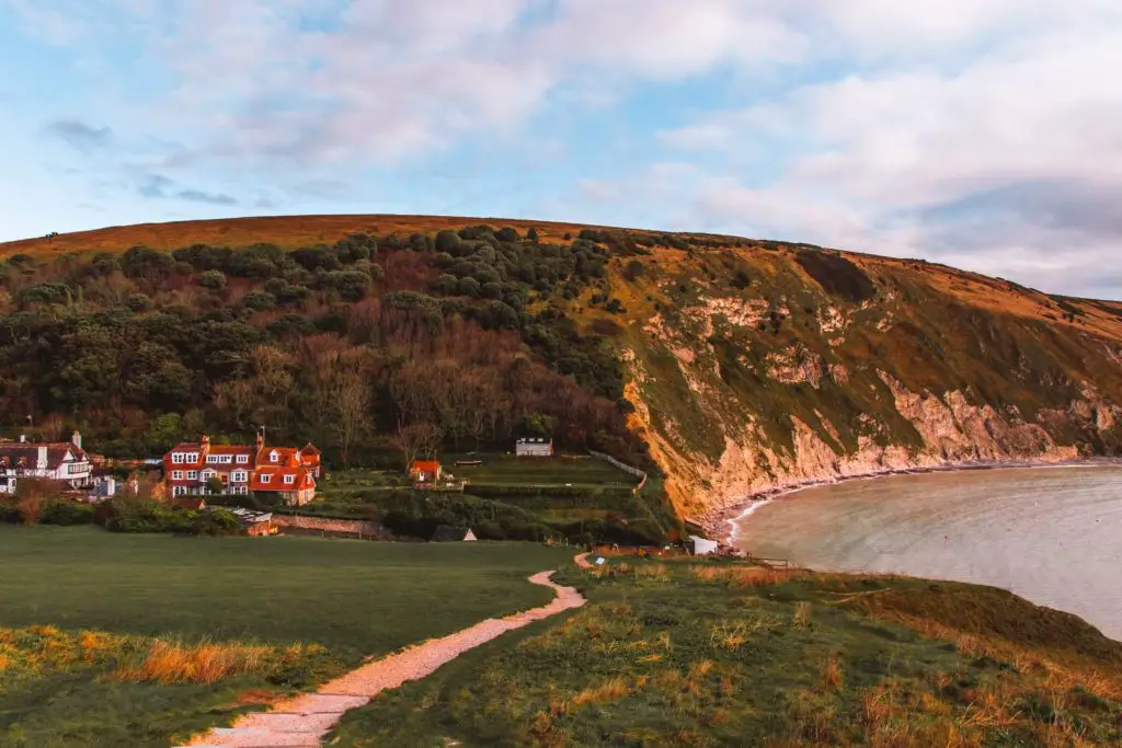 Lulworth village in a valley with the cove on the right at the start of the walk to Durdle Door.