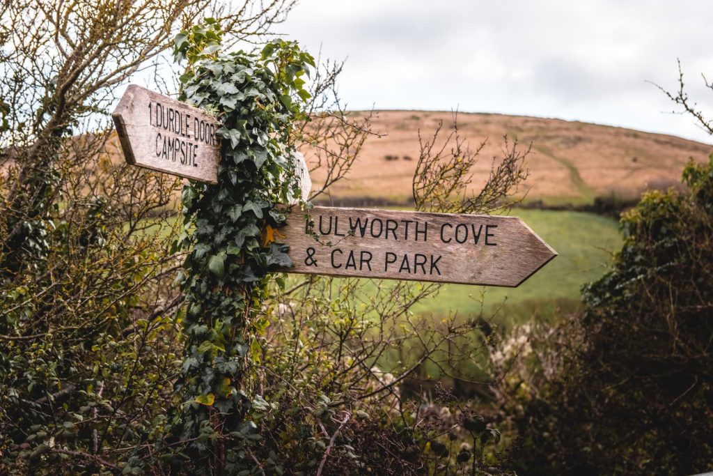 Signage pointing to Lulworth Cove on walk back from Durdle Door.