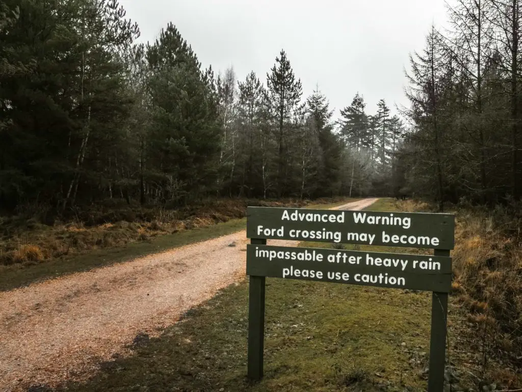 Signage warning of impassable trail after heavy rain.