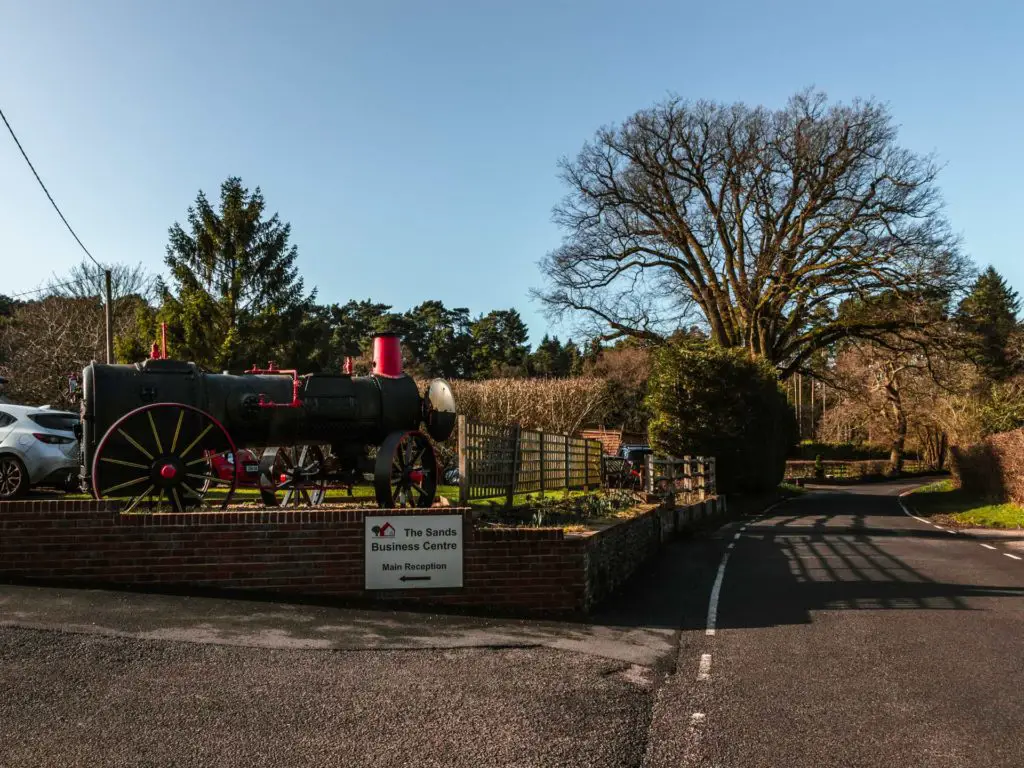 A steam train on the side of the road on display.