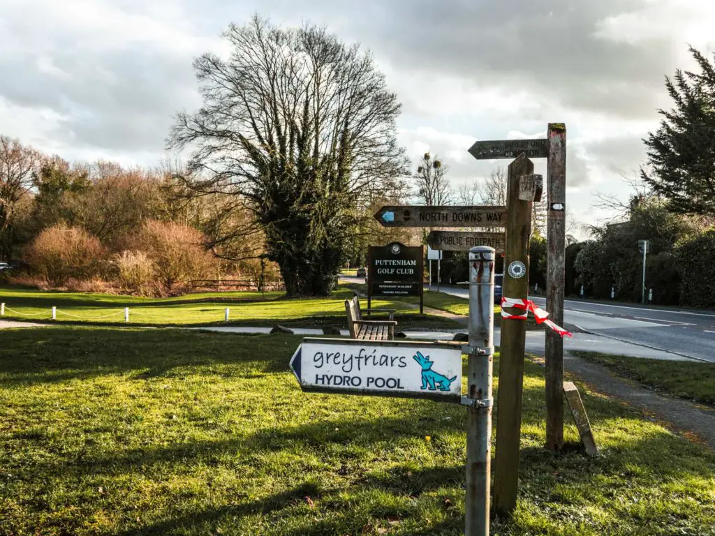 Signage pointing to the North Downs Way, a hydro pool, and a golf club.