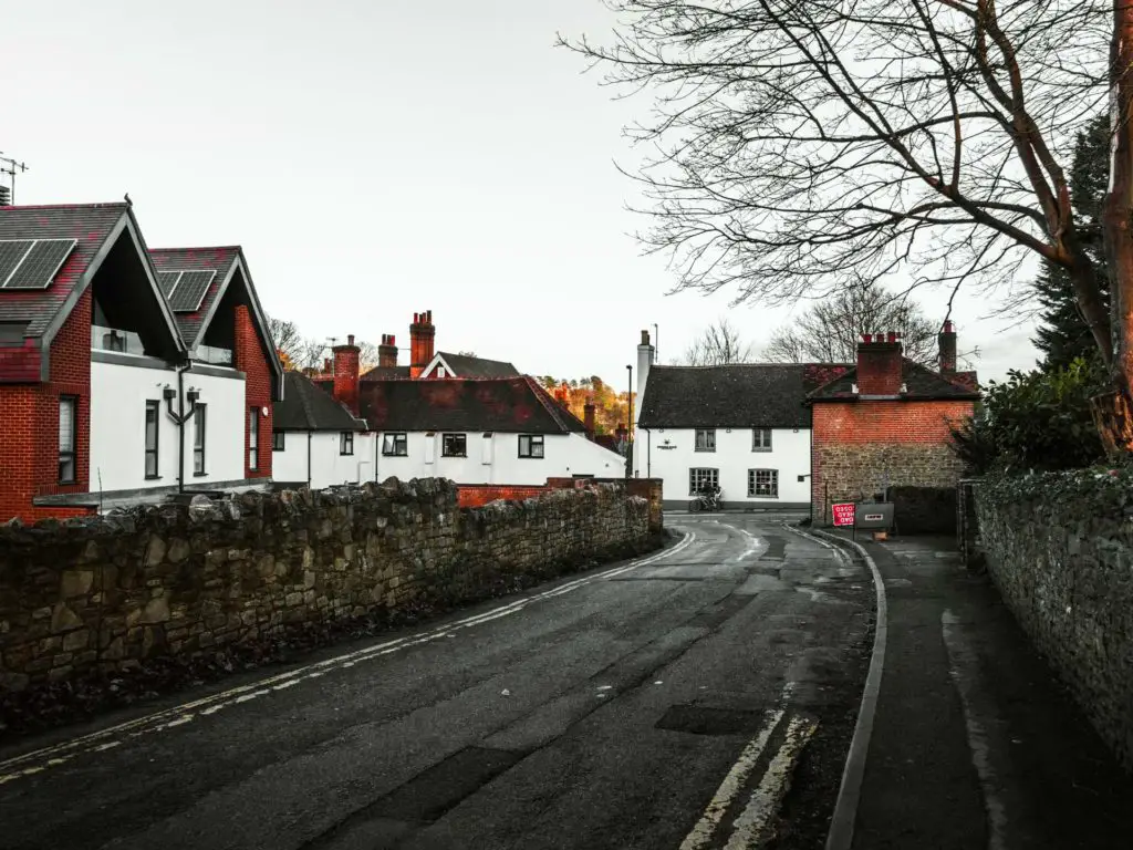 The main road with houses on the left and at the end of the road in Guildford. 