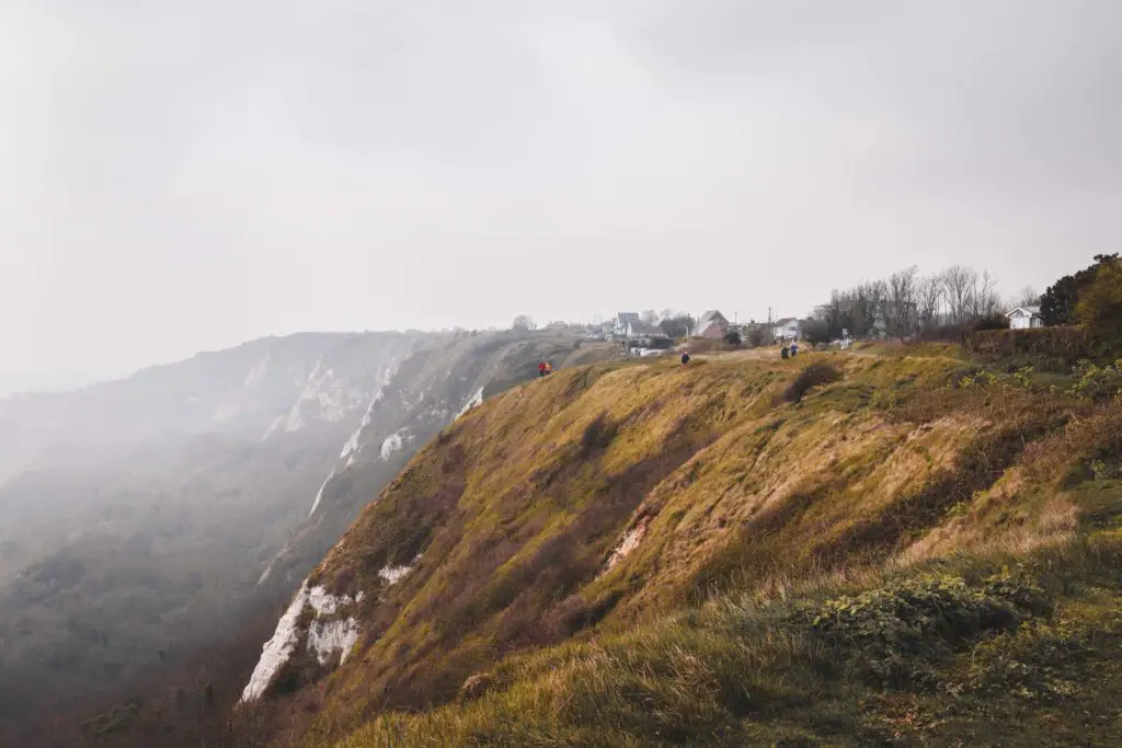 Hiking trail on the edge of the green grass covered cliff from Folkestone to Dover on the English coastal path.