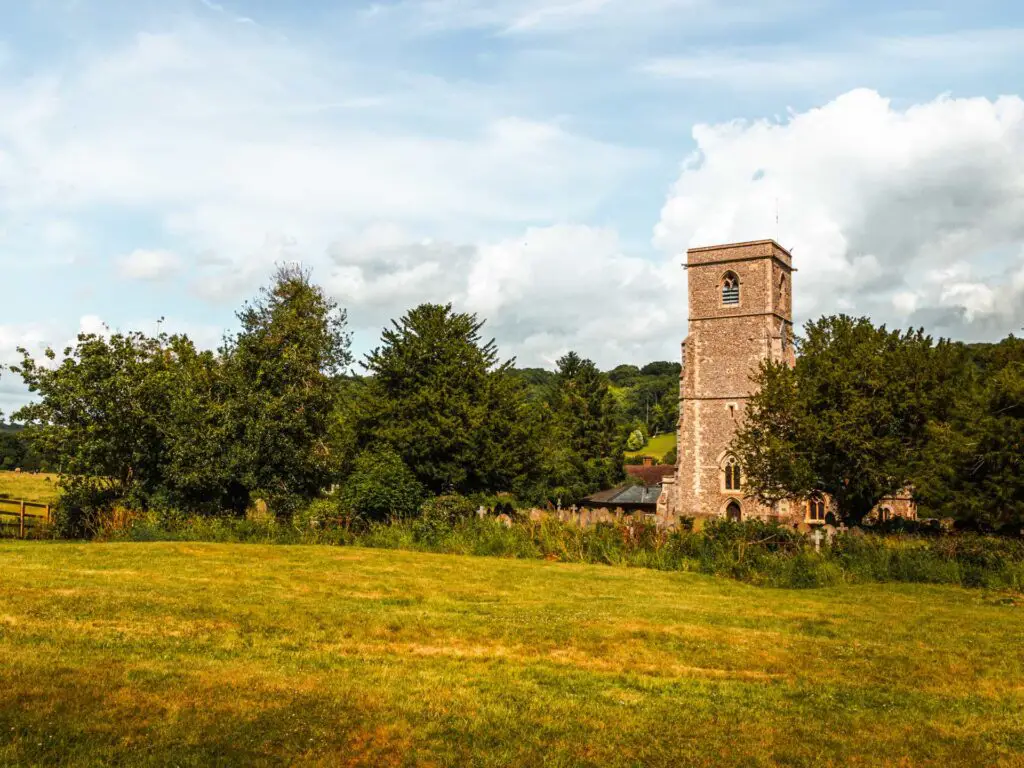 A church on the other side of a green field in the Chilterns.