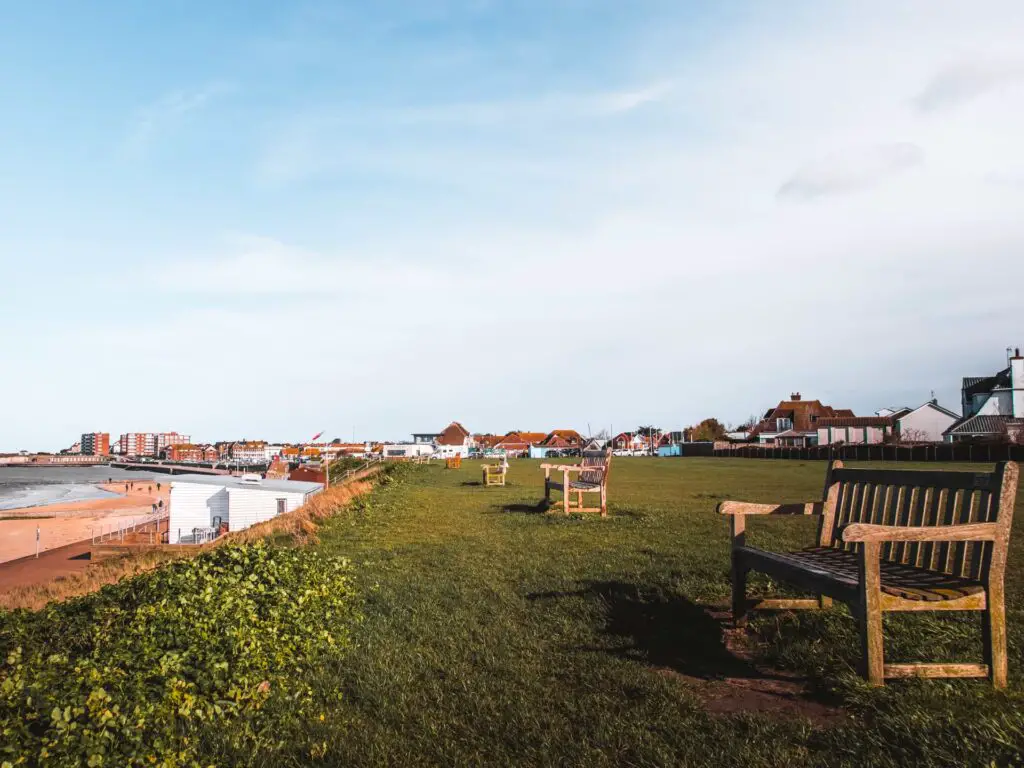 A grassy patch with benches facing out to sea on the walk from Herne Bay to Margate via Reculver.