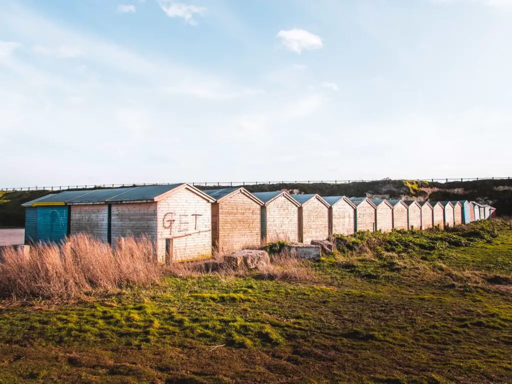Lots of shabby beach huts facing away from the sea towards the end of the walk from Herne Bay to Margate via Reculver.
