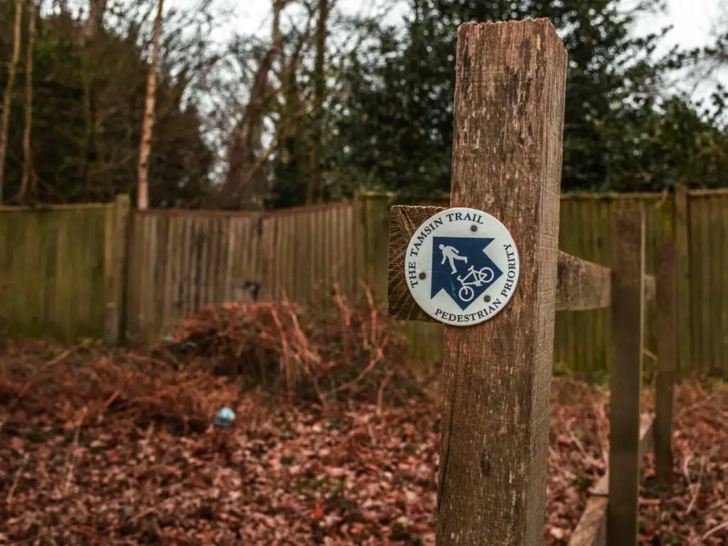 A wood stump with Tamsin trail signage on it.