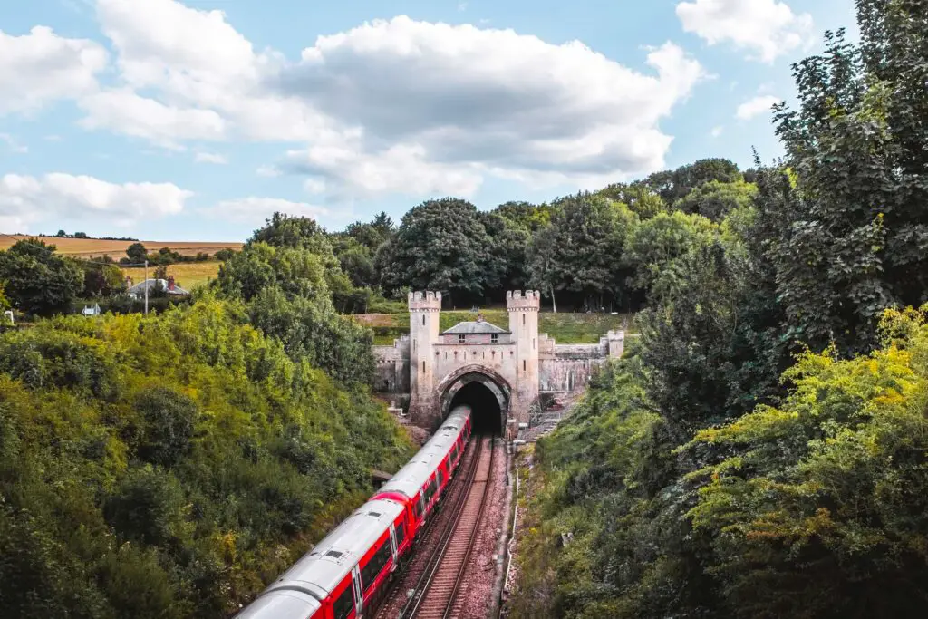 A train running along train tracks and through a tunnel on the circular walk from Hassocks to Devils Dyke.