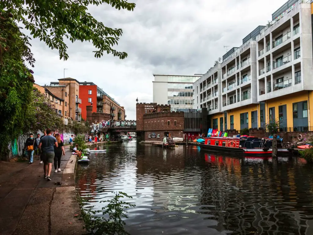 Regents Canal as it leads to Camden, at the end of the walk from Little Venice. There are lots of people on the path and buildings up ahead.