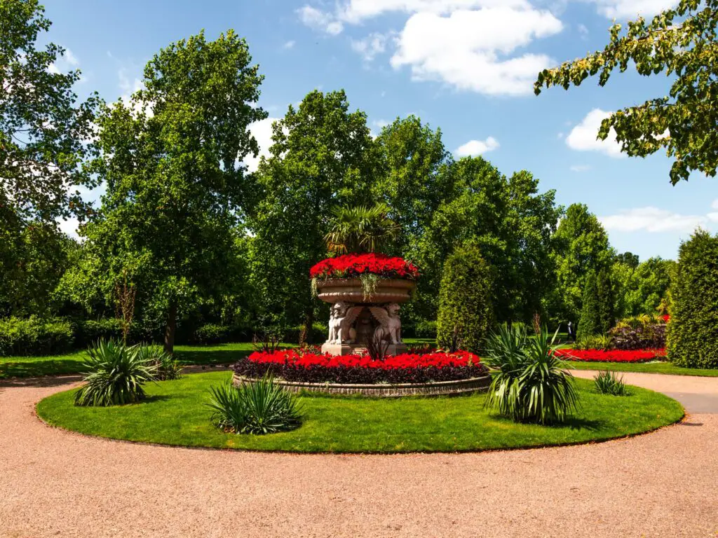 A sculpture with red flowers on the walk from regents park to primrose hill.