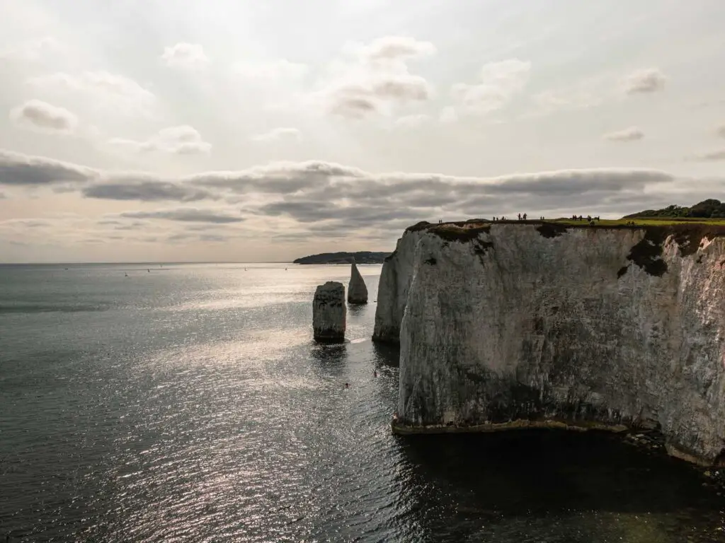 The white cliffs of Old Harry Rocks with the dark blue sea below.