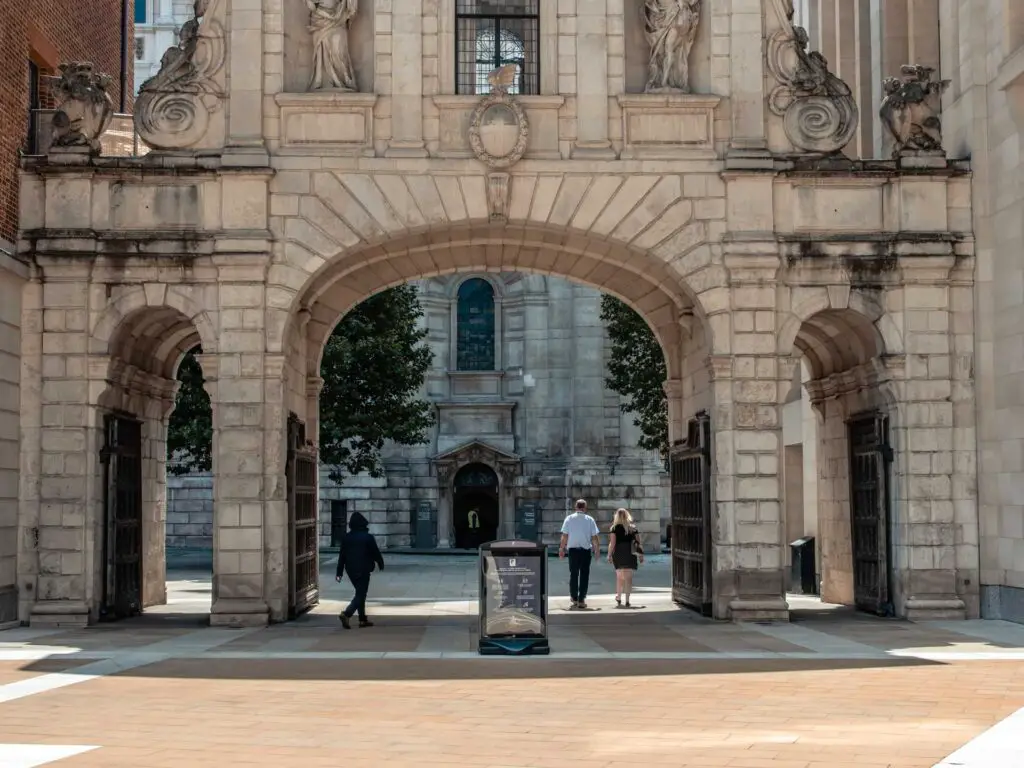 Temple Bar Gate archway in the city of London, with people walking through it.