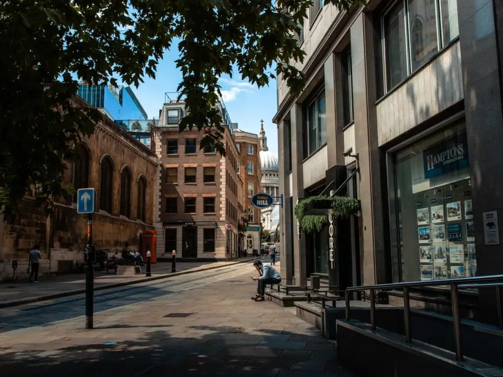 A road and alley leading towards the just about visible St Pauls Cathedral on the City of London walk.