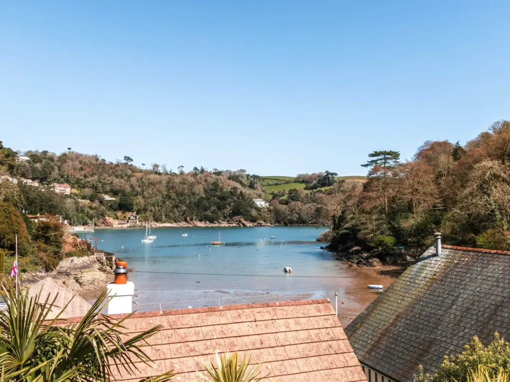 Rooftops and lots of greenery enclosing the river dart on the walk to Dartmouth Castle.