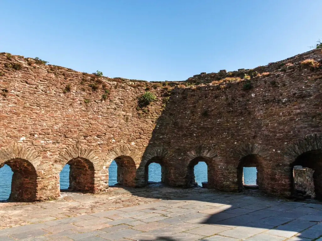 The brick Bayards fort with window holes lining the bottom with the blue river visible through them.