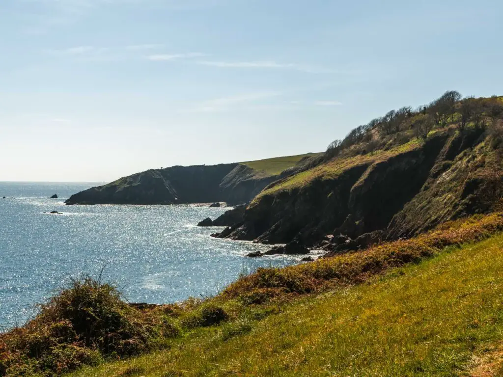 A cliff coastline view across the green on the walk to Little Dartmouth.