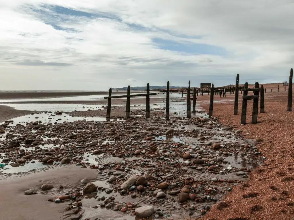 The sea bed with lots of pebbles and rocks on the Rye walk.