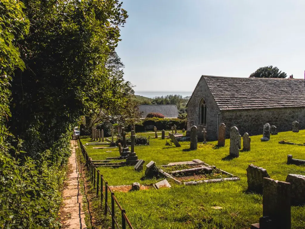 A path leading along the left of a church and graveyard. 