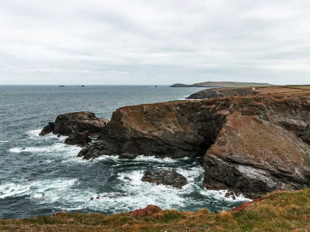 The rough blue sea as it crashes into the rugged cliffs in Cornwall.