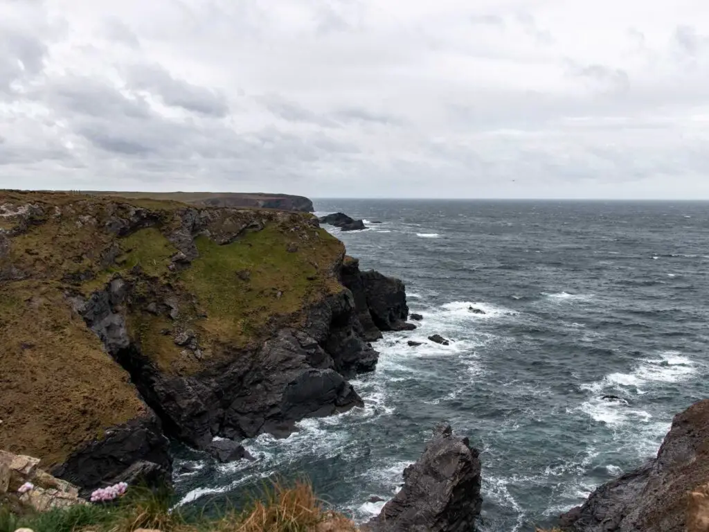 Looking along the cliff coastline where it meets the sea.