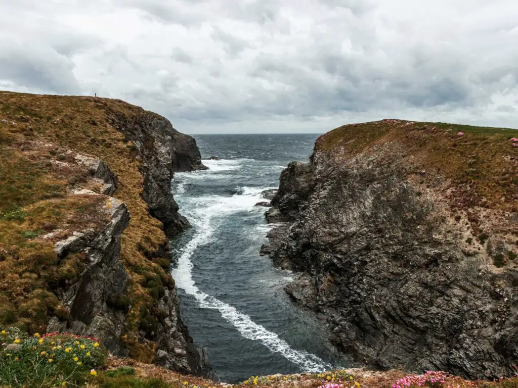 A view down into a cliff cove on the coastal walk between Porthcothan and Treyarnon in Cornwall.