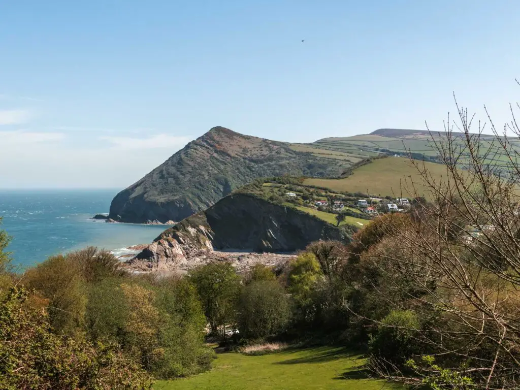 Looking down at the green and then the hilly coastline behind it in North Devon.