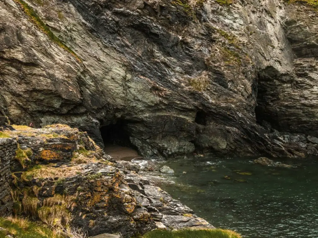 A craggy cliff with a Merlins cave under it.