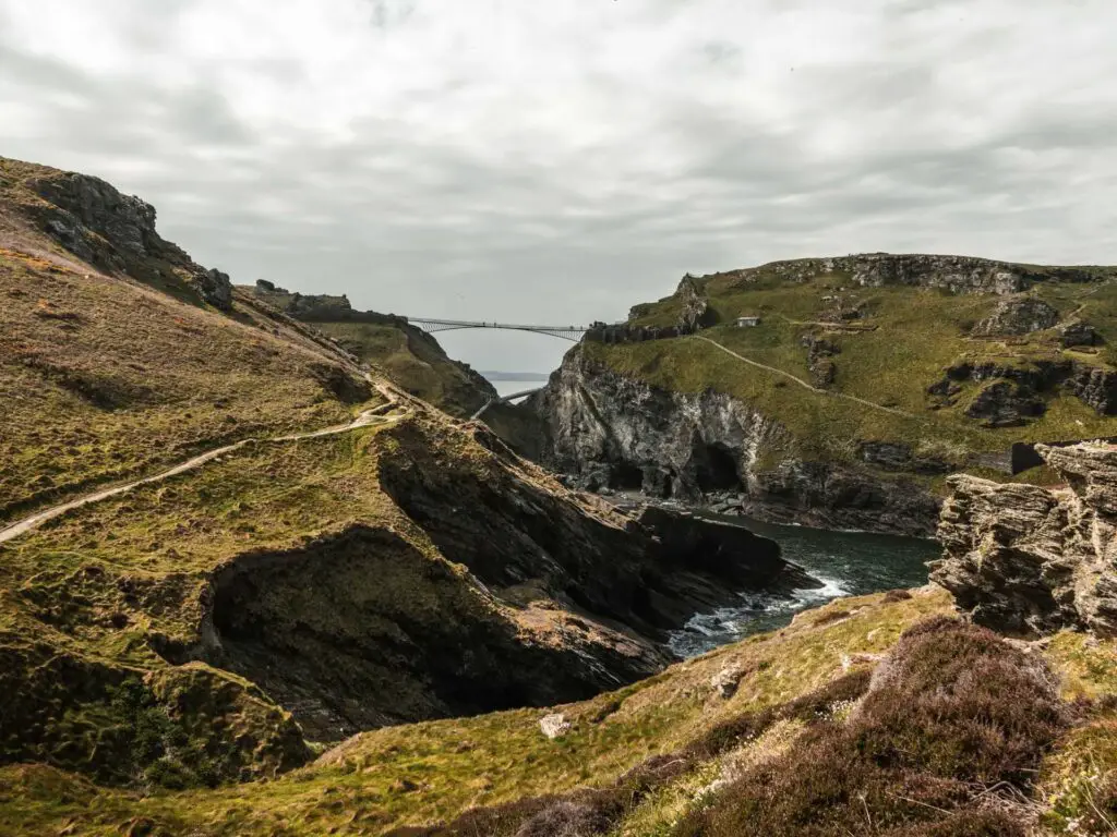 Rugged hills surrounding the sea on the walk from Tintagel. There is a walking trail running across one of the hills, and a bridge between Tintagel island and the mainland.