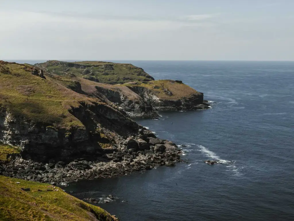 The blue sea as it meets the cliff coastline.