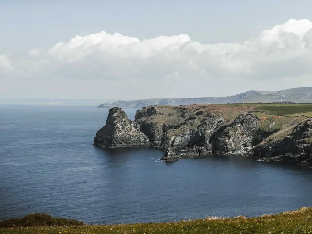 The blue sea as it meets rugged cliffs on the coastal walk from Tintagel to Bossiney.