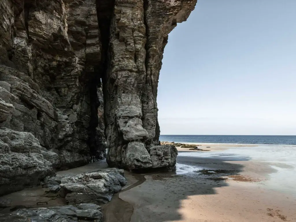 Elephant nose rock formation on the sandy beach of Bossiney Cove.