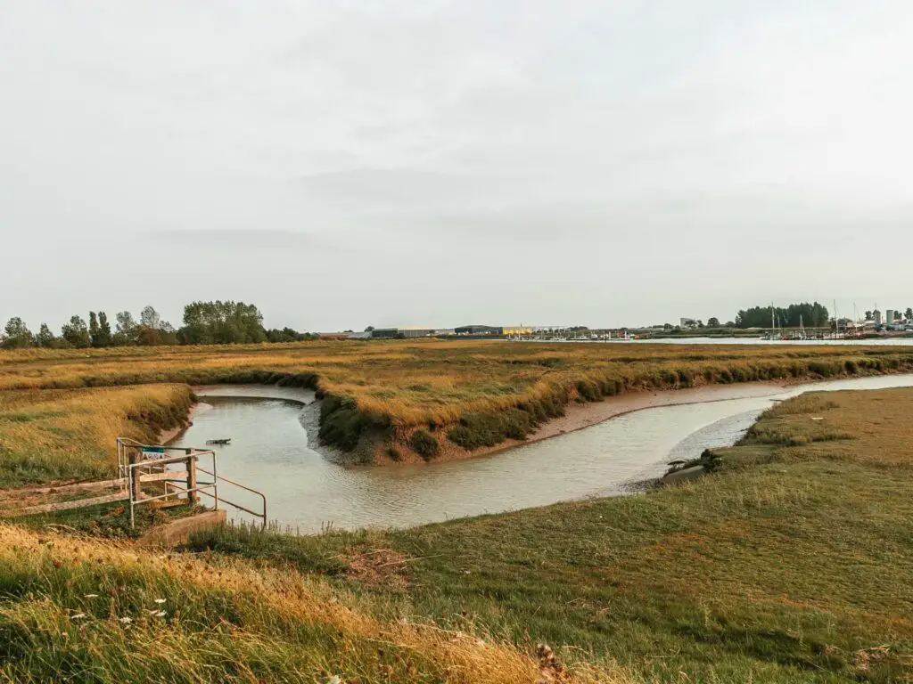 A river bend through the green marsh land along the walk from Rye to Camber Sands.