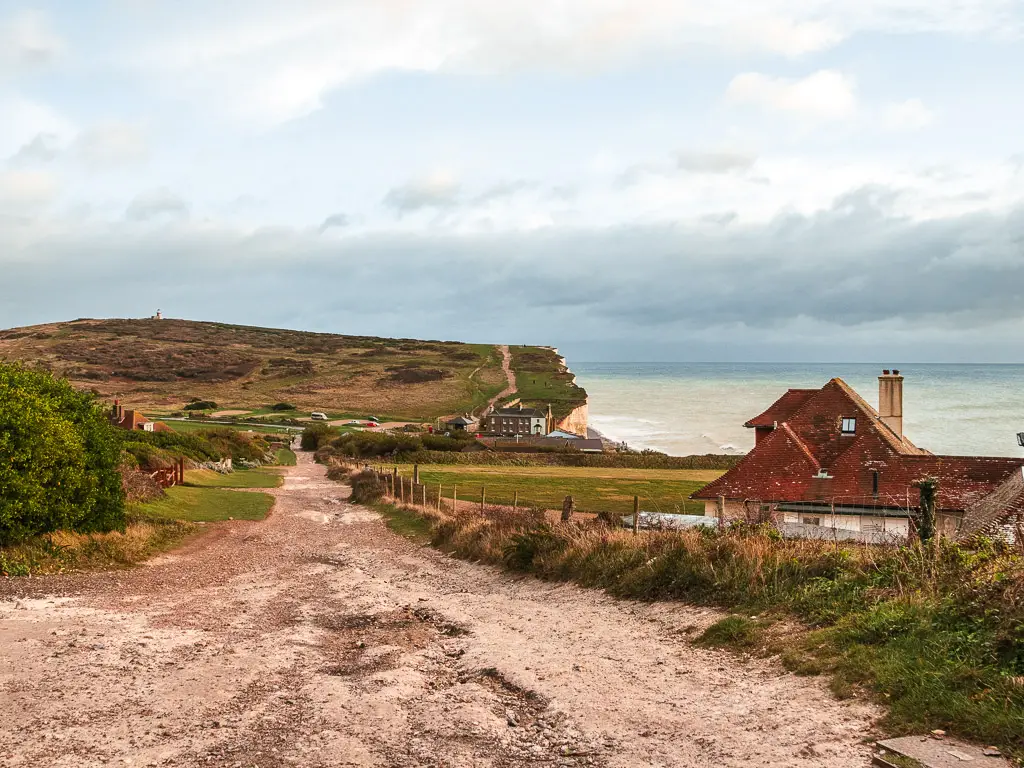 The road leading downhill at the end of  the walk back from Friston Forest  into Birling Gap at the bottom. 