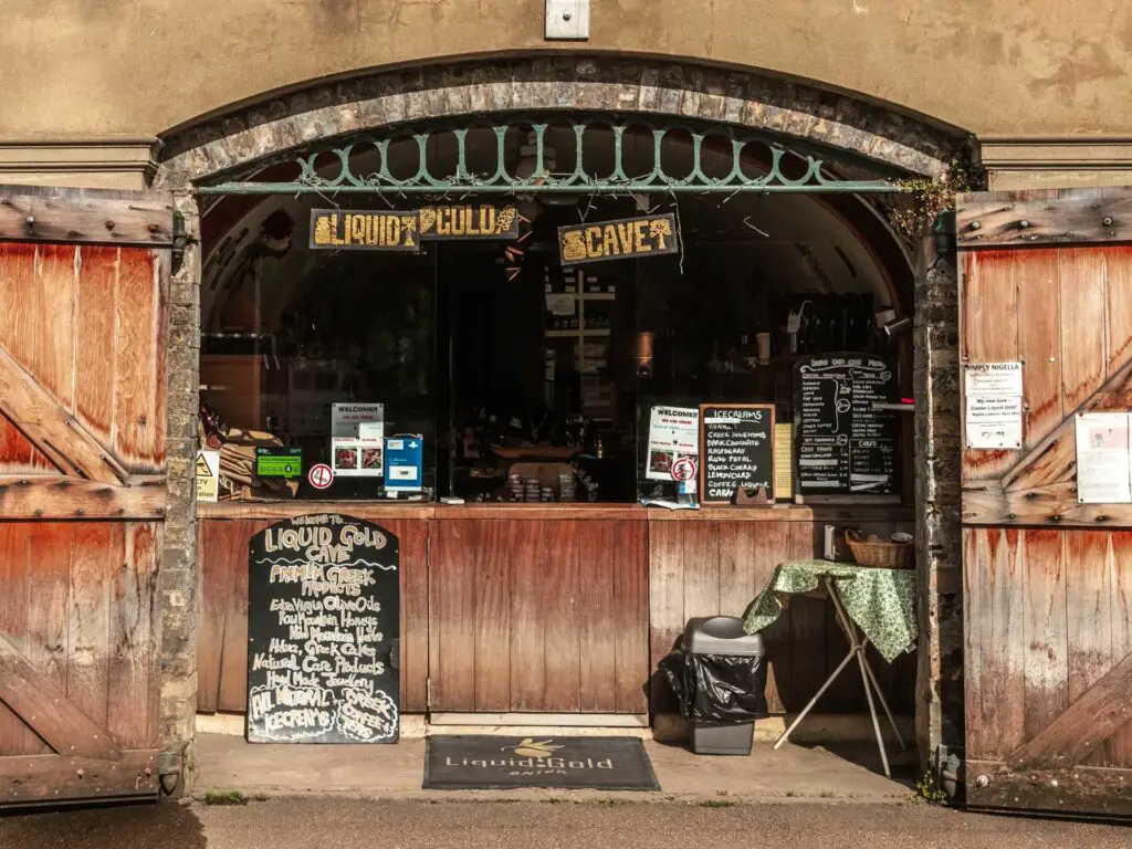 An archway shop with open wooden doors.