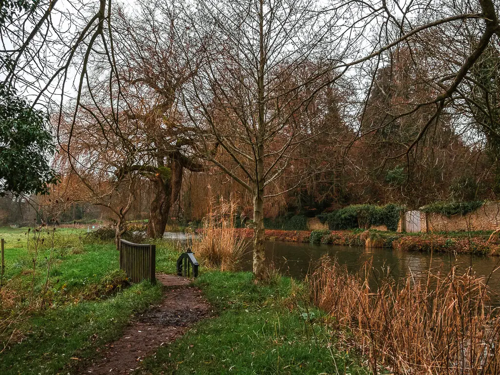 A dirt trail leading over a small bridge .