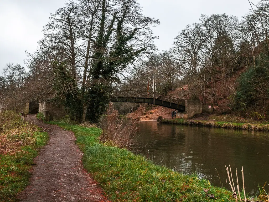 The trail running next to the River Wey on the walk from Guildford to Godalming. There is a bridge crossing the river.